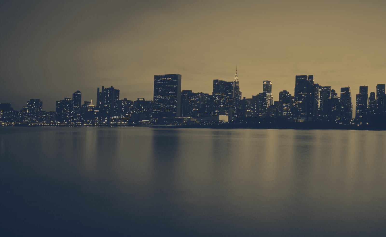 The New York skyline at dusk, lit in gold